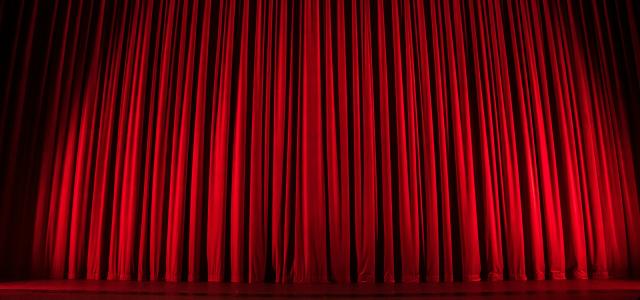 red theater curtain by Rob Laughter courtesy of Unsplash.